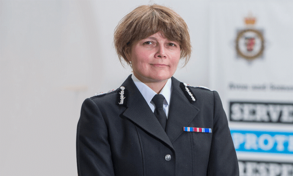 Chief Constable Sarah Crew standing in front of an Avon and Somerset Police banner. 