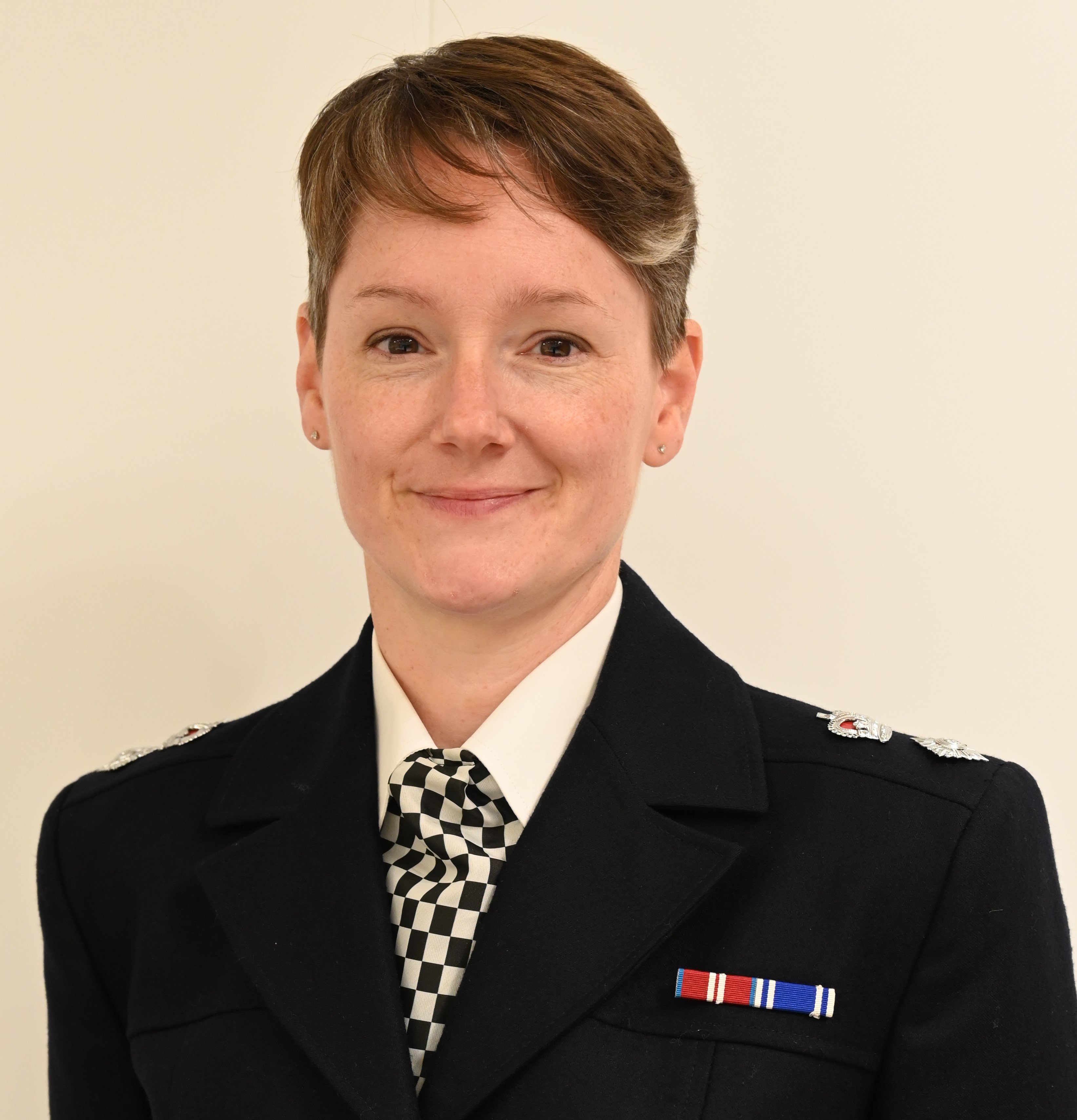 Chief Superintendent Claire Smart in uniform, smiling to camera.
