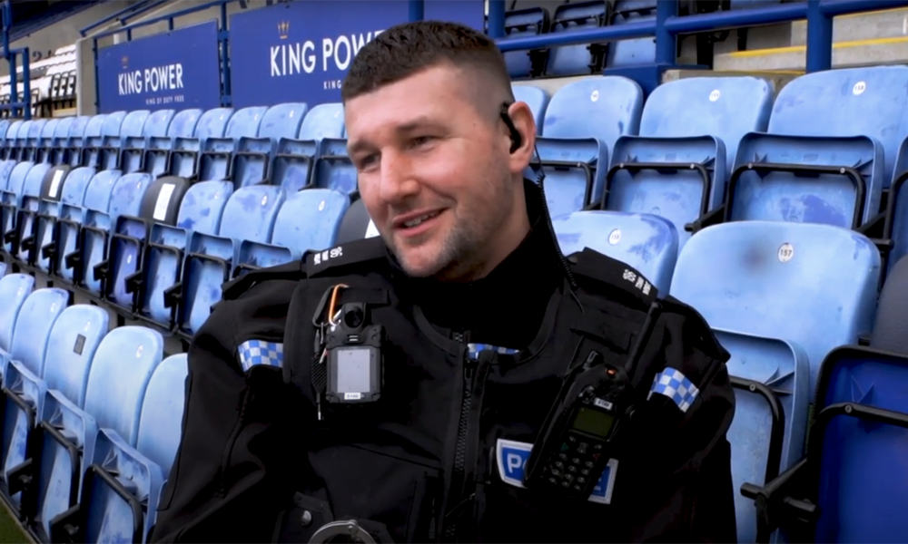 Tommy Wright sitting in the stands of a football ground.