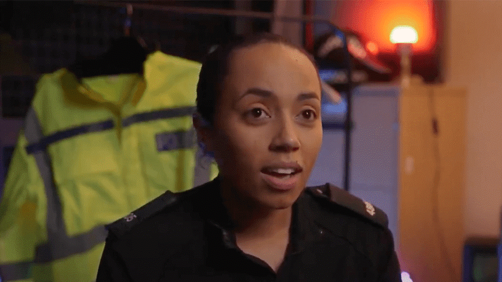 Yasmin talking to camera, locker room in the background. 