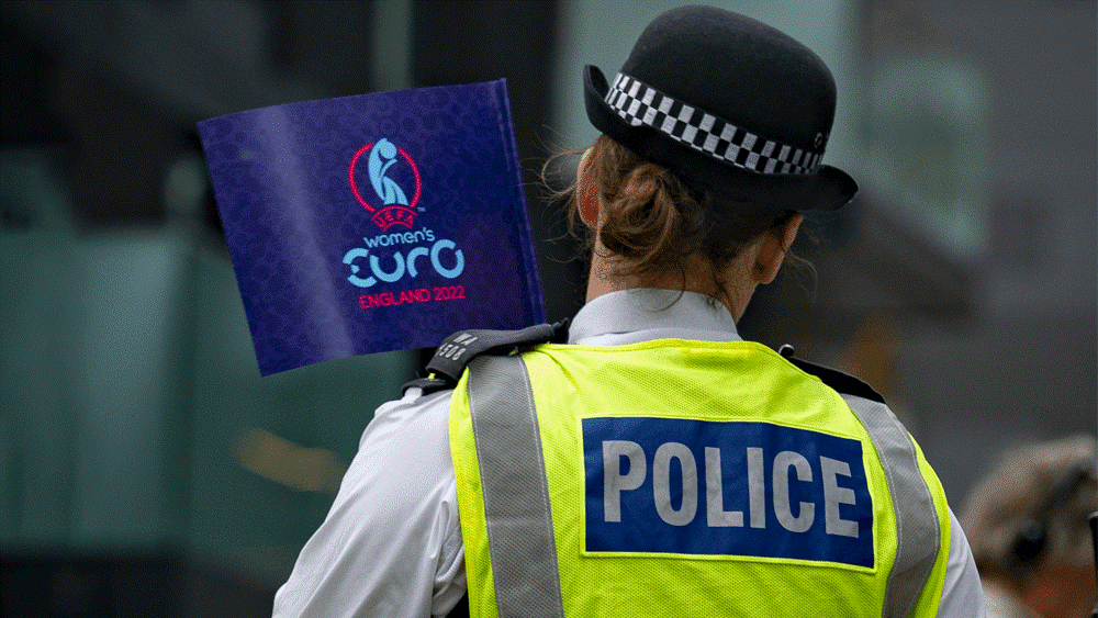 Female officer shown from the back holding a EUROs sign.